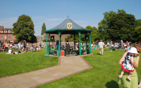 Bandstand, with crowd behind. Band playing inside.