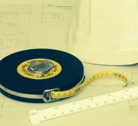 Tape measure, hard hat, scale rule and plans