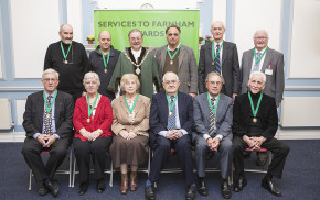 10 males and 2 females sitting after receiving awards.