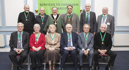 10 males and 2 females sitting after receiving awards.