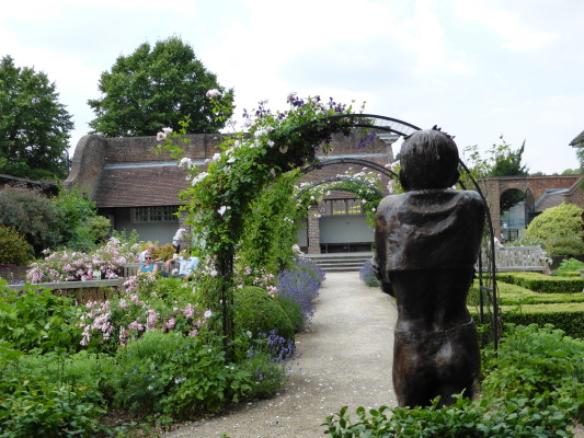 Floral archway with sculpture.