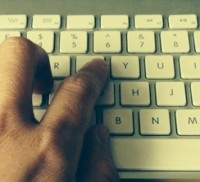 Hand typing on keyboard.