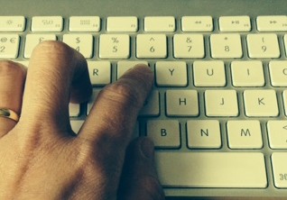 Hand typing on keyboard.