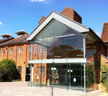 exterior of brick building, with glass doors.