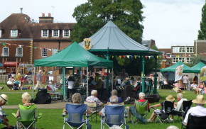 People, bandstand, music in the meadow.