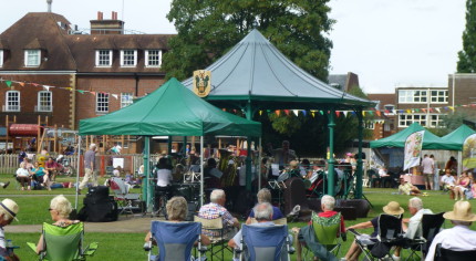 People, bandstand, music in the meadow.