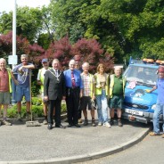 People next to a blue van