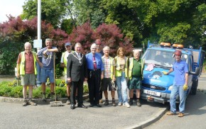 People next to a blue van