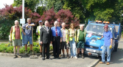 People next to a blue van