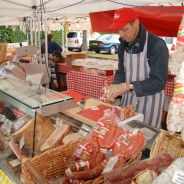 Stall with various meats and male stallholder