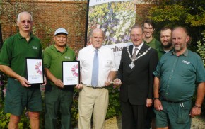 Seven men including Mayor, holding certificates and trophy for Farnham in Bloom.