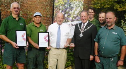 Seven men including Mayor, holding certificates and trophy for Farnham in Bloom.