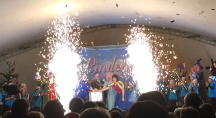 Stage, cast of Cinderella, fireworks, Christmas lights.