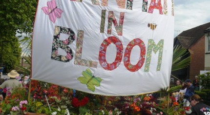 Trailer, Farnham in Bloom banner, flowers on trailer. Carnival float.