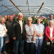 Mayor and a group of people standing inside a large poly tunnel