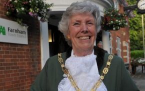 Head and shoulders of female Mayor dressed in green Mayoral robes and chain.