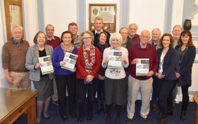 Group of people holding copies of the Farnham Neighbourhood Plan