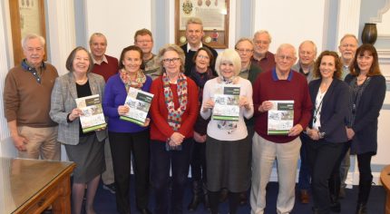 Group of people holding copies of the Farnham Neighbourhood Plan