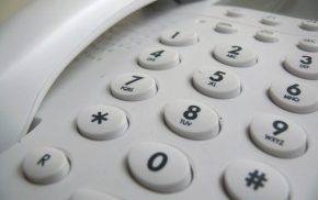 Close up showing push buttons on a white telephone